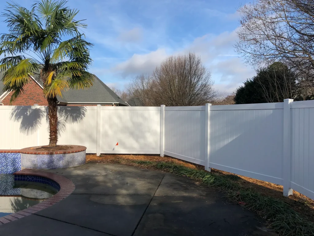 White vinyl fence on lawn